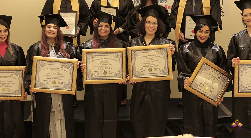 Group of diverse medical professionals graduating the board certification in cosmetic gynecology, demonstrating techniques with modern equipment in a professional classroom setting.